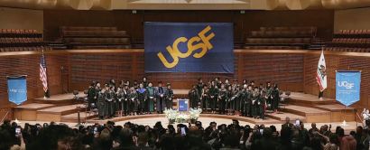 Davies stage with faculty, audience, and UCSF banners.