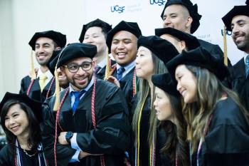 many graduates pose for a group photo.