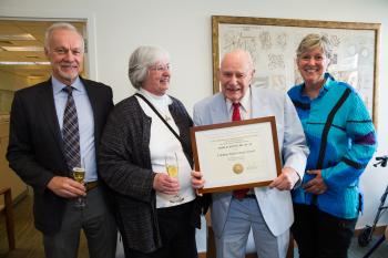 John Kenny holding certificate, with family