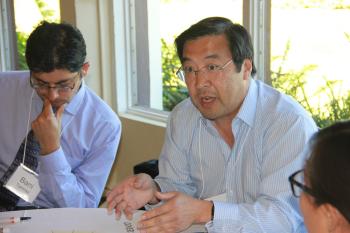 a faculty member speaks in a small group.