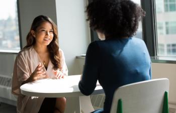 Two women having a conversation at a table