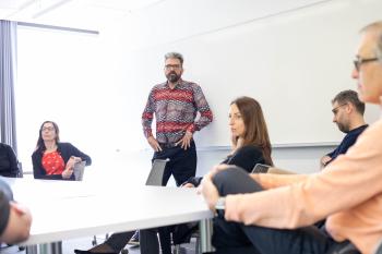 Krogan in classroom with colleagues