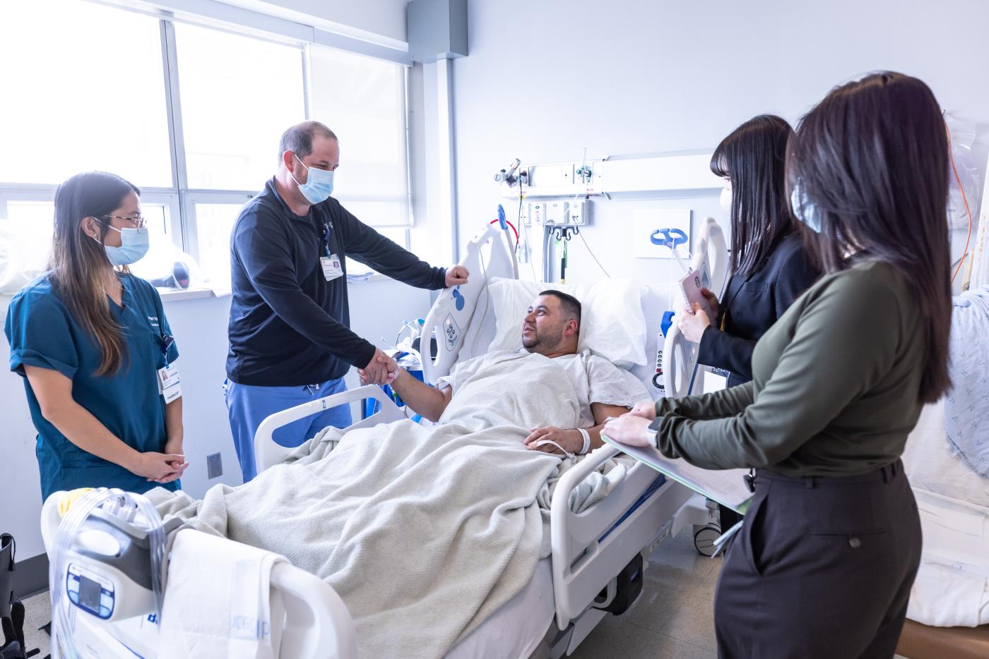 Pharmacist and pharmacy students with patient 