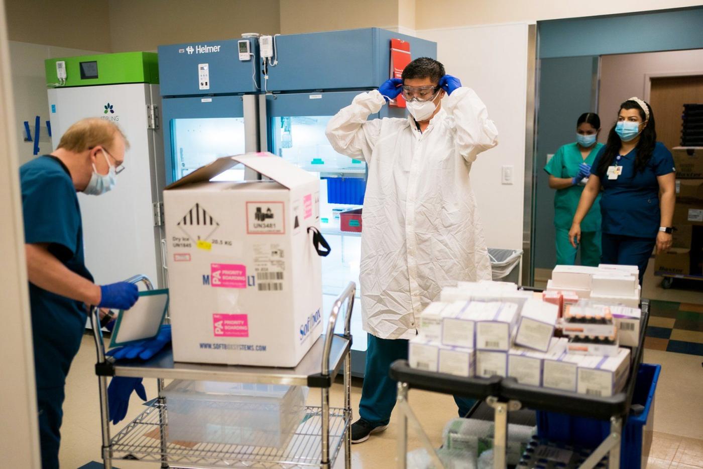 UCSF Pharmacy staff with FedEx box of vaccinations
